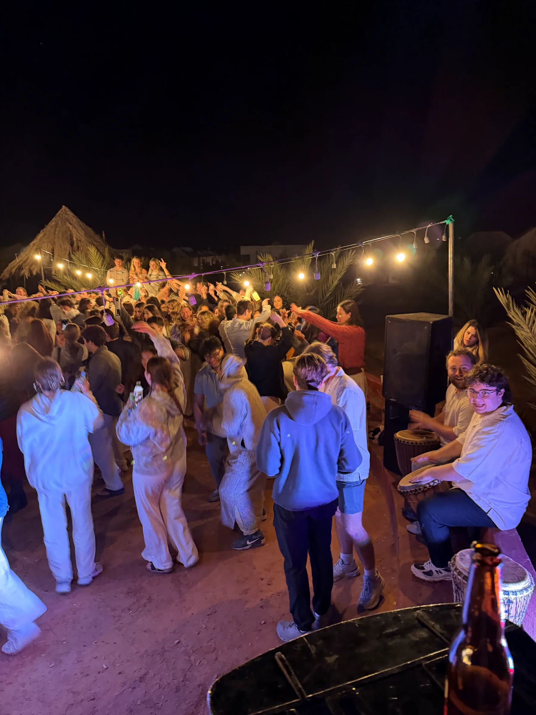 Travelers together during an evening at a shared desert camp