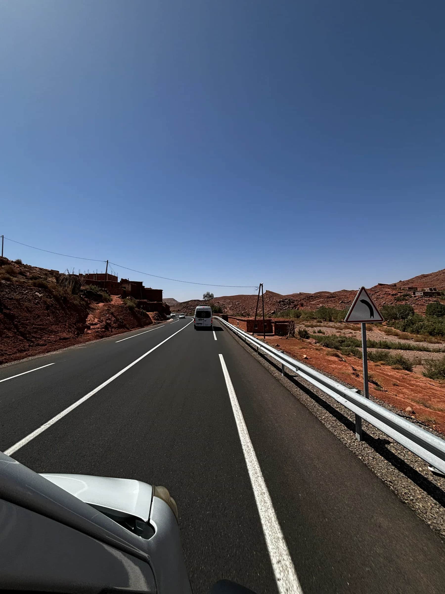 A vehicle travelling along a Moroccan road toward the mountains