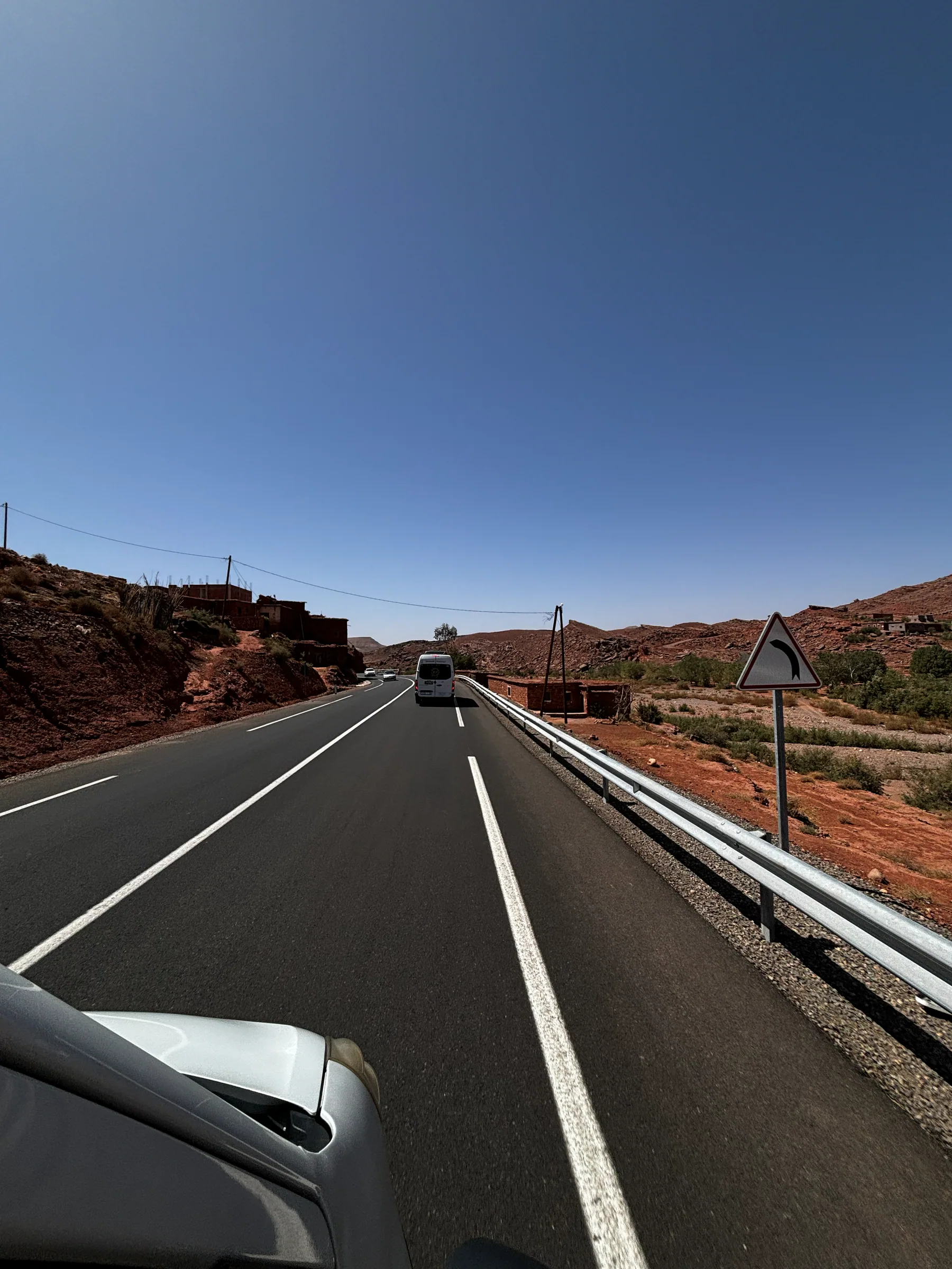 A vehicle travelling along a Moroccan road toward the mountains